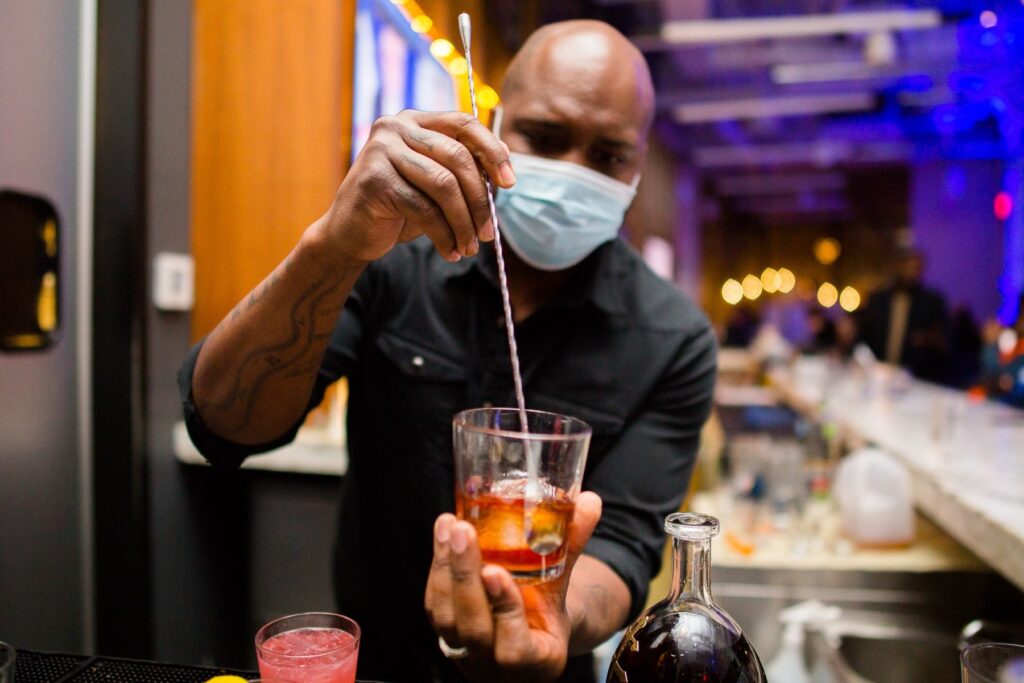 Bar tending preparing a drink at The Gathering Spot