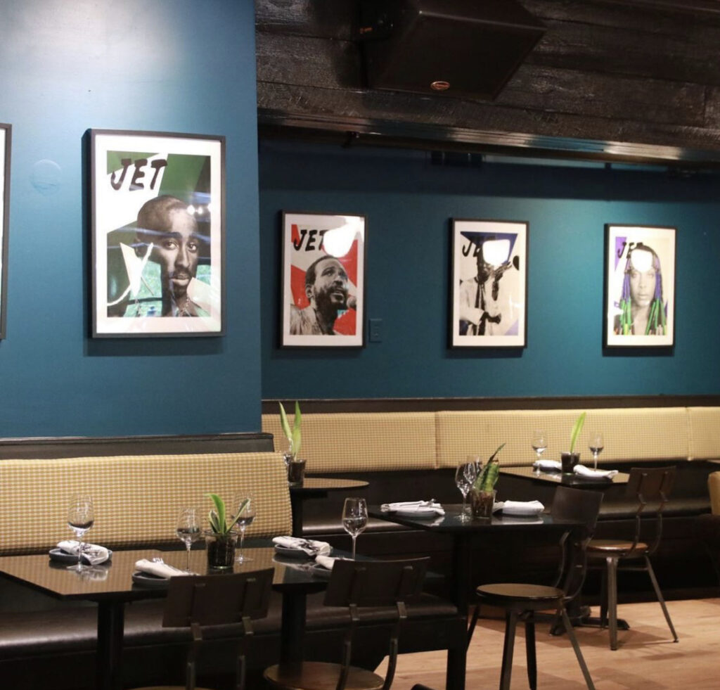 Restaurant with wooden furniture ad pictures of icons on the wall at APT 4B