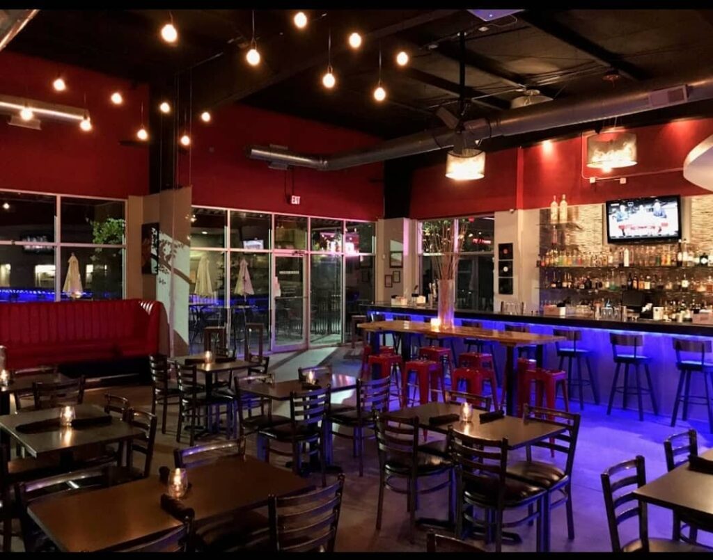 Brightly lit bar and restaurant at CalaBar & Grill