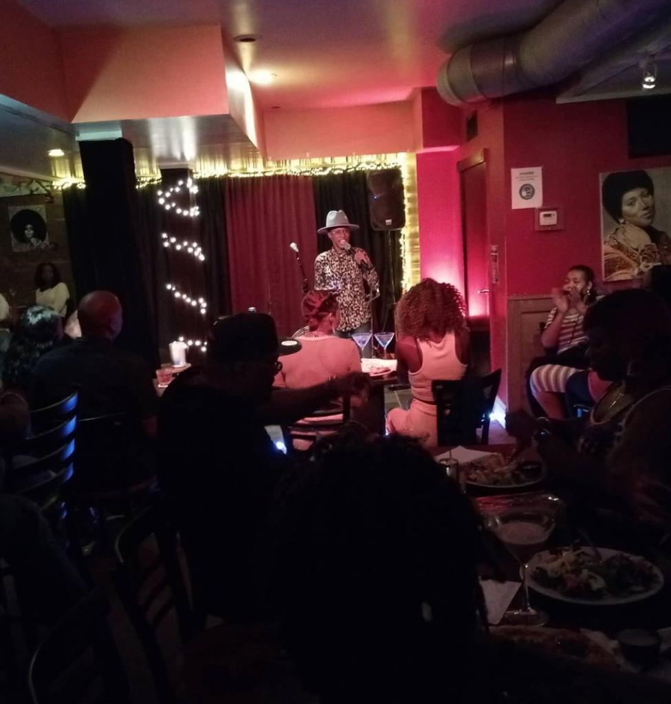 Man performing on stage at Kat's Cafe