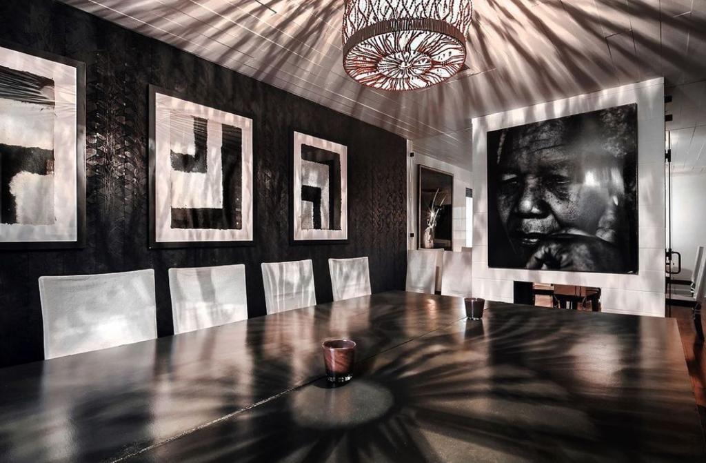 Portrait of Nelson Mandela overlooking a black and grey themed room at Ten Degrees South